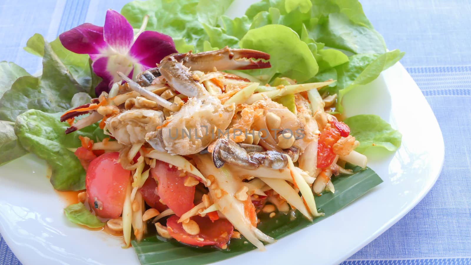 Traditional thai cuisine spicy green papaya salad with crab