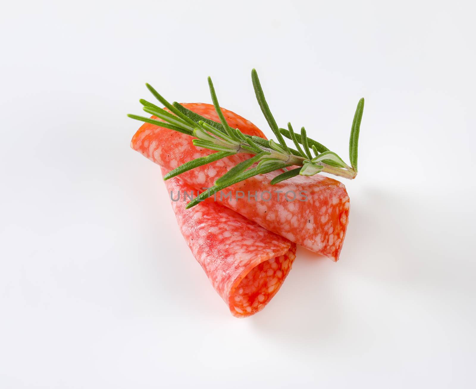 Thin slices of Hungarian salami and fresh rosemary