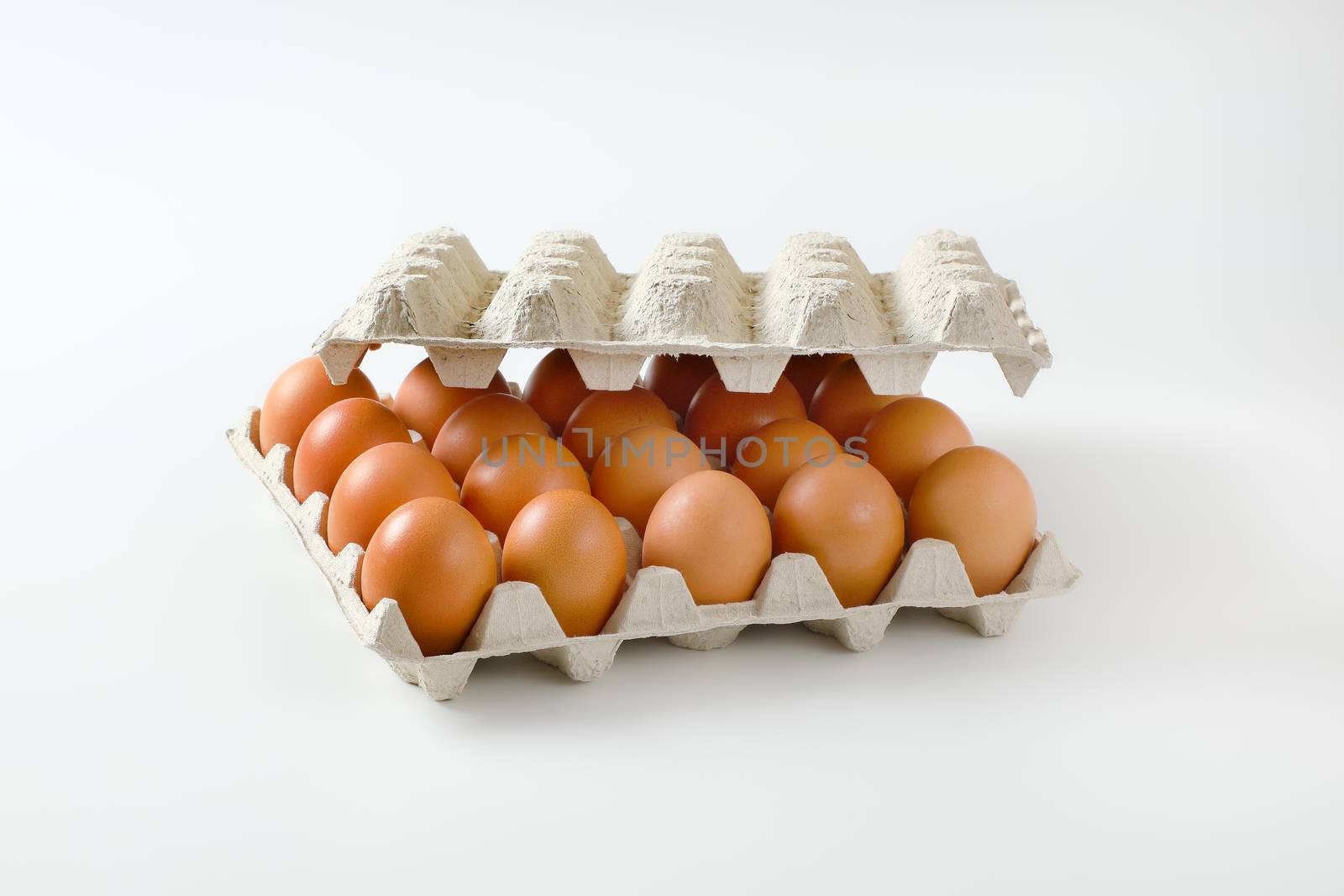 Twenty fresh brown eggs in a paper egg tray