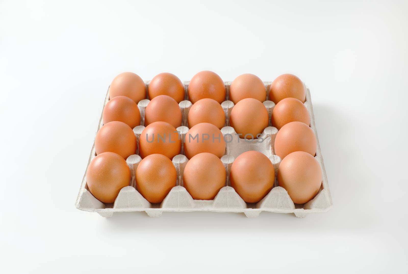 Fresh brown eggs in paper carton by Digifoodstock