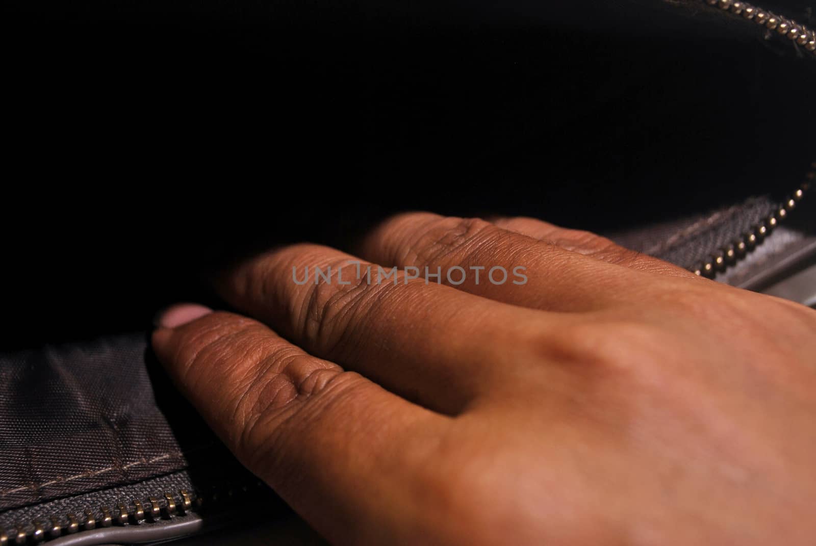 The thieves pickpocket money bags.Asian male hands.