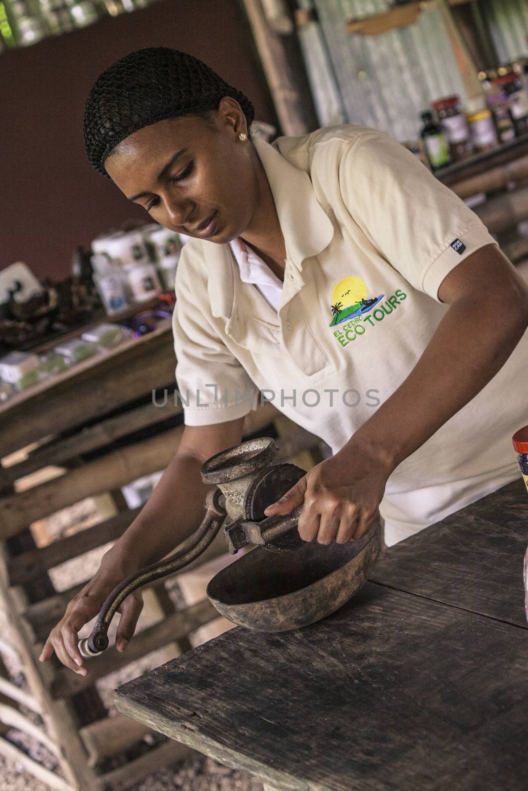 Dominican woman grinds coffee with traditional methods 2 by pippocarlot