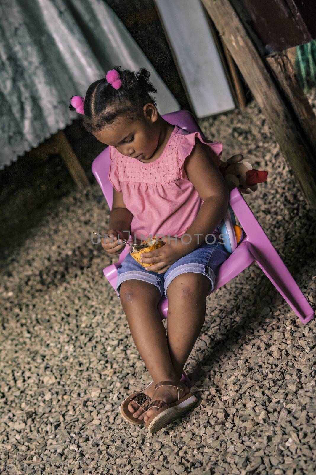 MONTANA REDONDA, DOMINICAN REPUBLIC 27 DECEMBER 2019: Dominican Child Sitted in a poor house