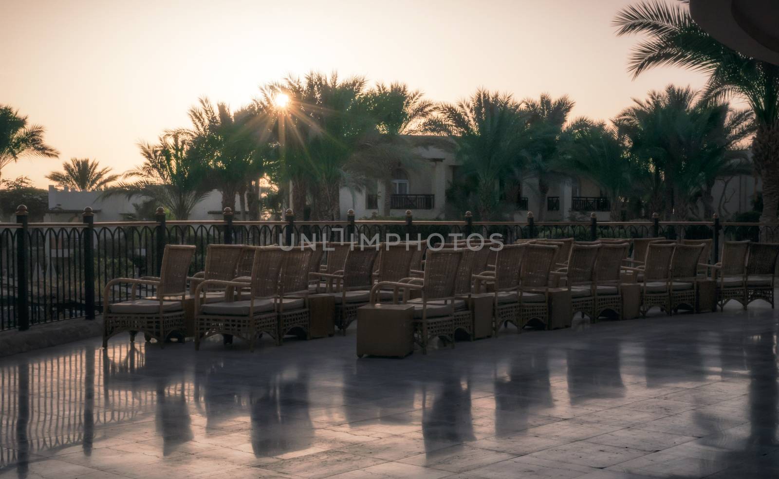 chairs on a terrace without people in a hotel at dawn with elephant rays in Sharm El Sheikh Egypt