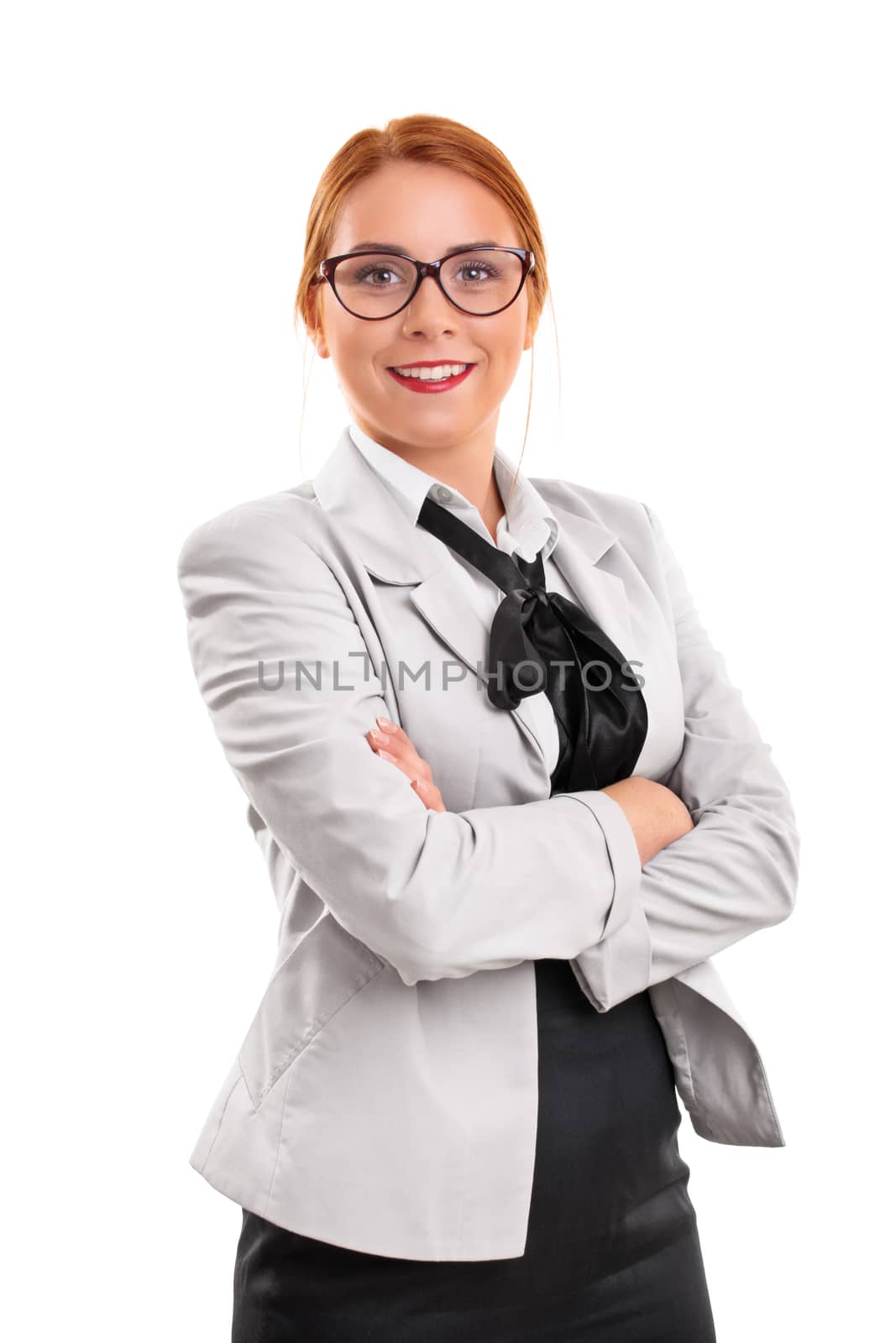 Beautiful smiling young fashionable businesswoman in a suit with folded arms in front of her, isolated on white background.