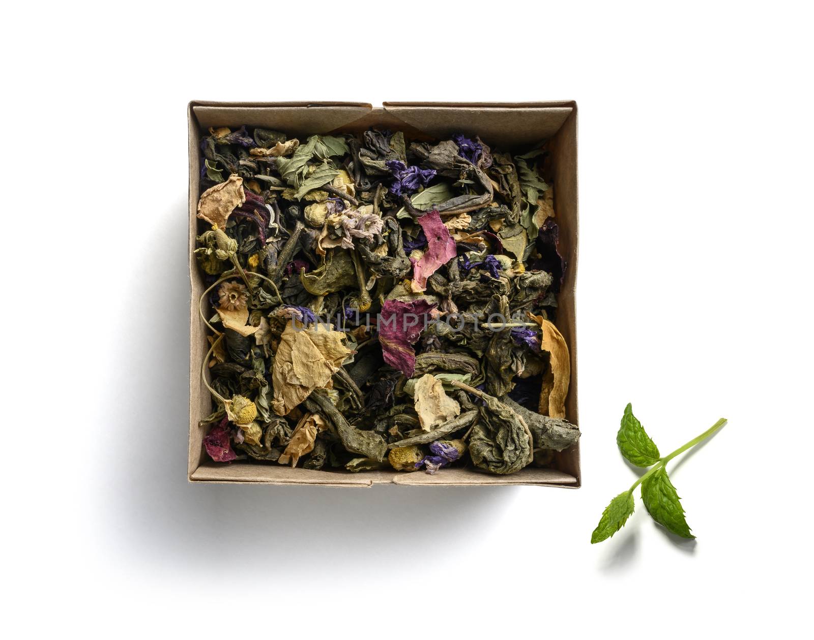 Green tea with natural aromatic additives. Top view on white background.