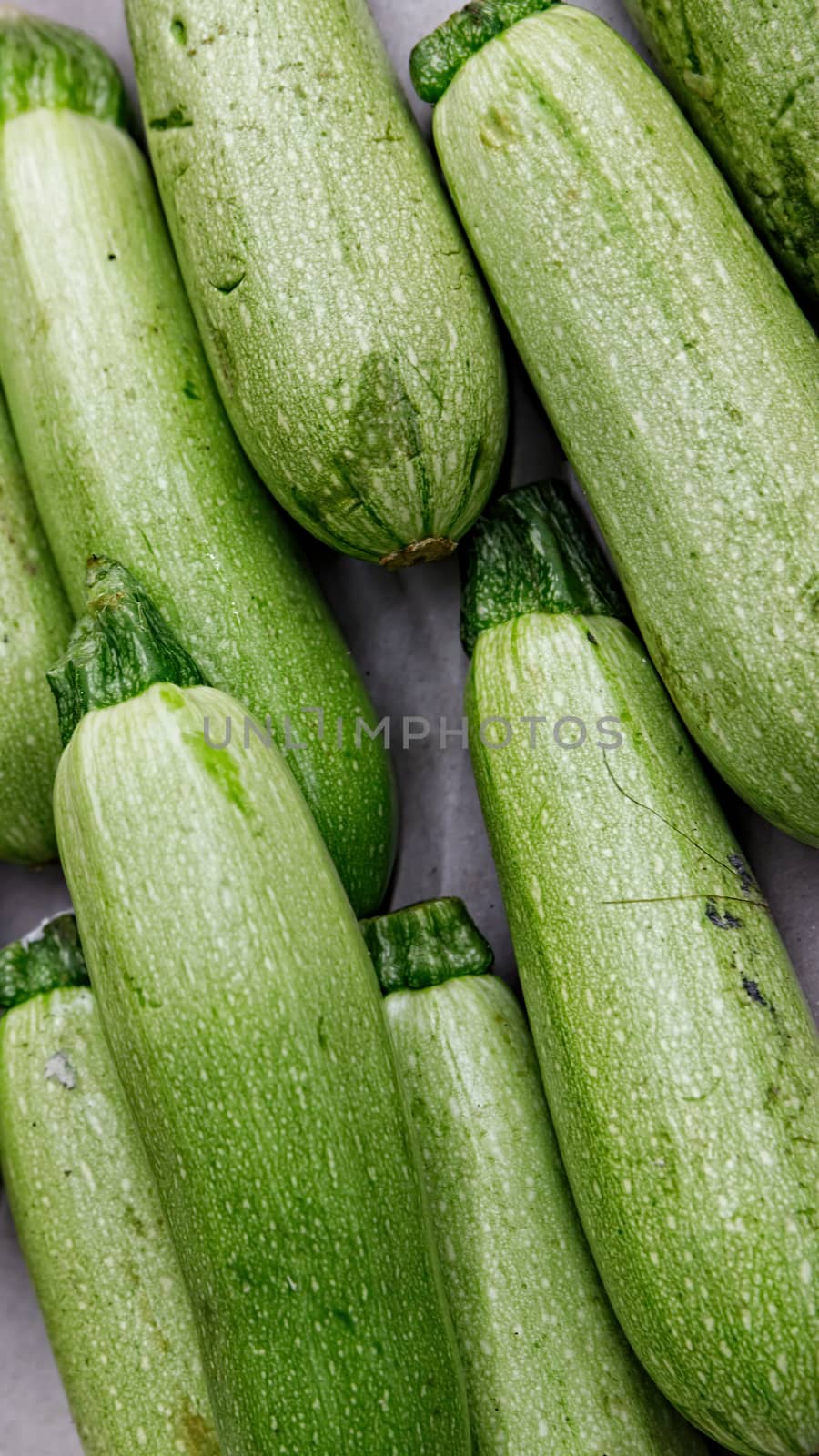 Fresh zucchini at the grocery store. Organic product suitable for vegetarians and vegans. Healthy eating concept