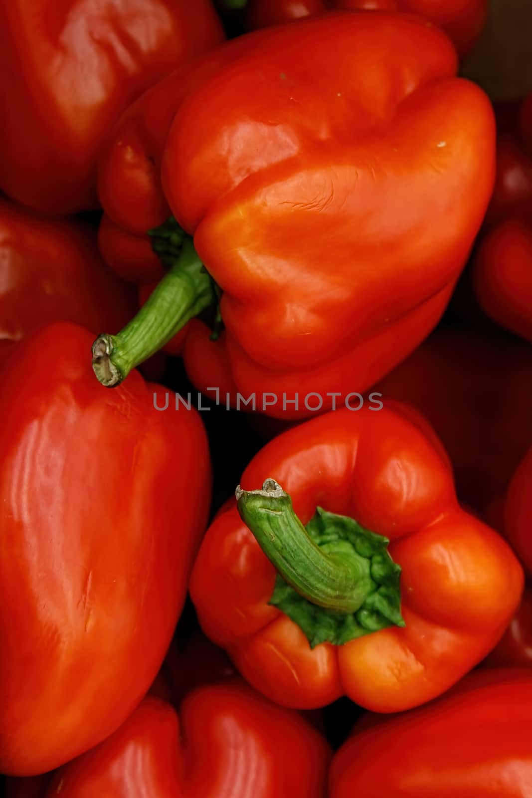 Abstract image of a bright red sweet pepper lying in a grocery store. The view from the top