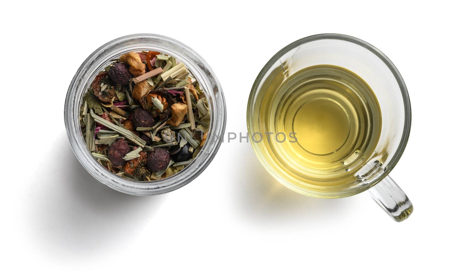 Green tea with natural aromatic additives and a Cup of tea. Top view on white background.