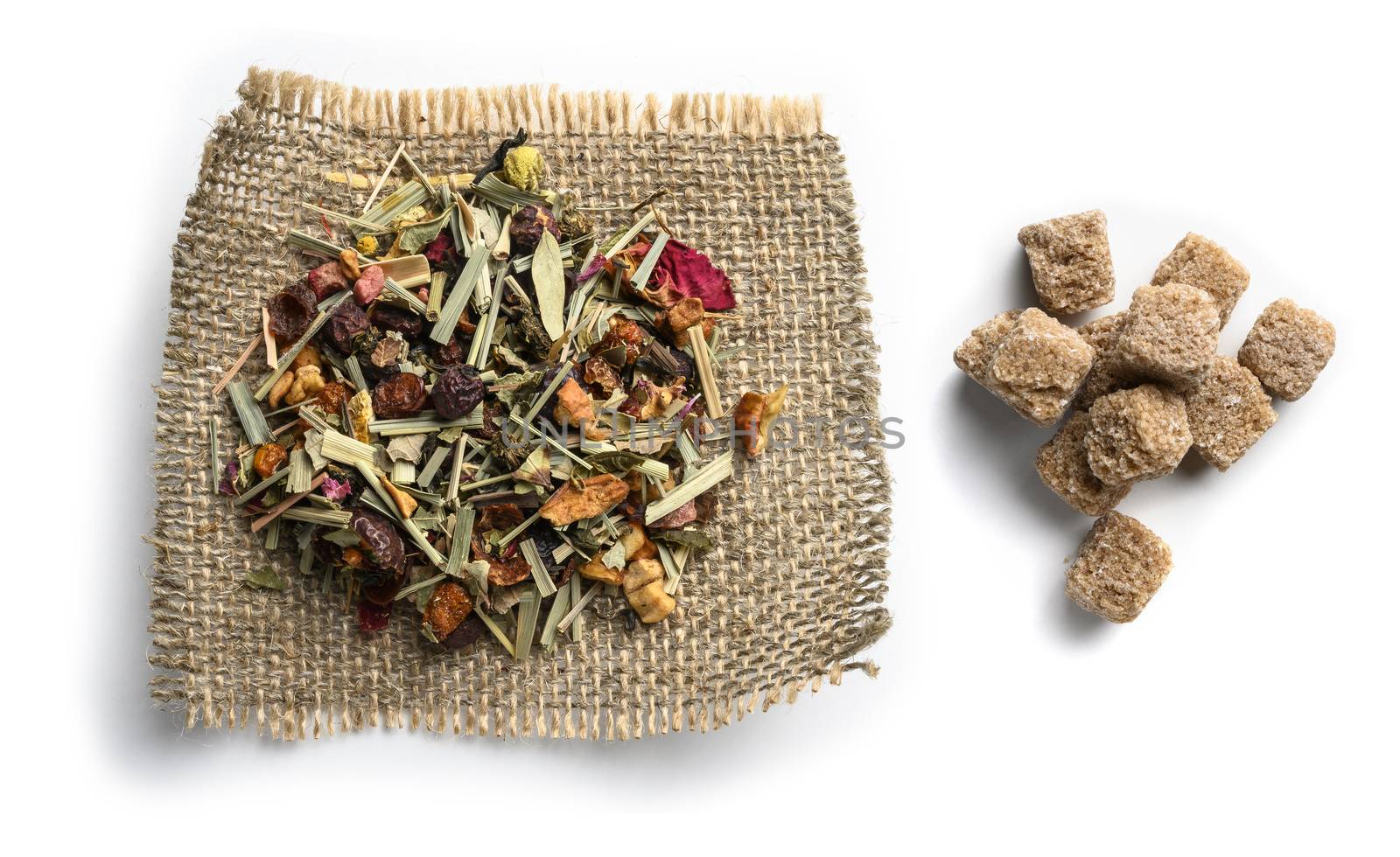 Green tea with natural aromatic additives and sugar. Top view on white background.