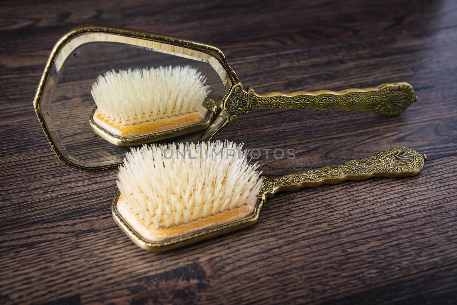 Vintage hair brush reflecting on a vintage hand mirror