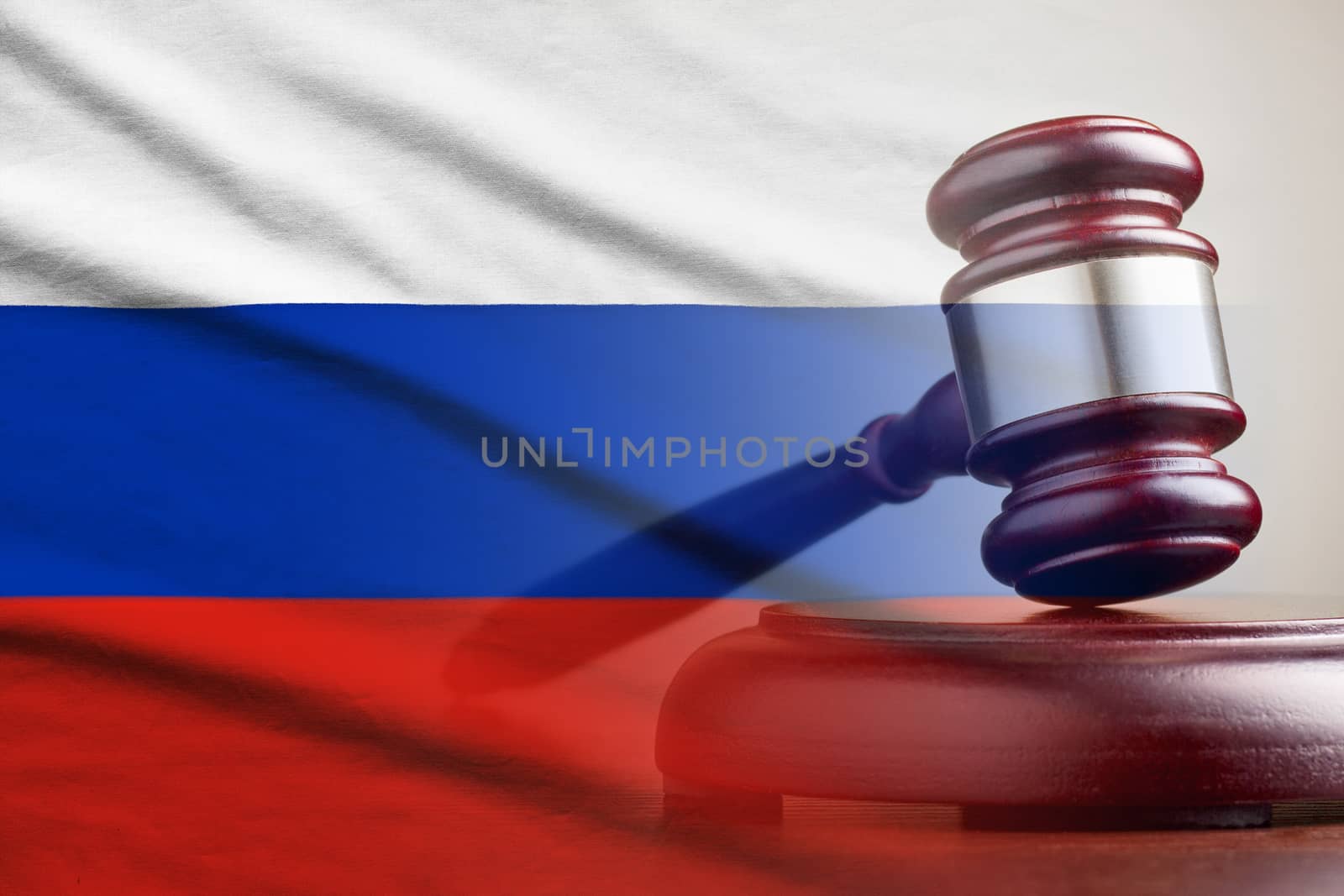 Legal gavel on its plinth over a flag of the Russia in a conceptual composite image
