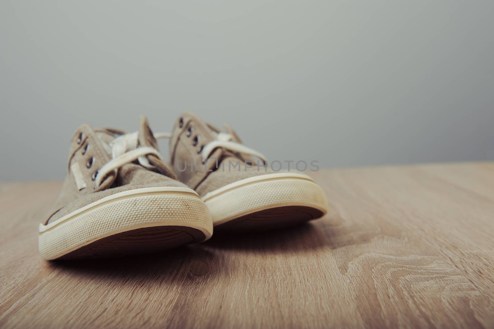Blue lovely used sneakers on wooden desk