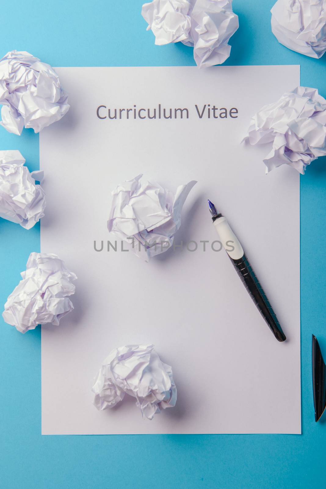 Curriculum vitae written on an blank white paper on blue background