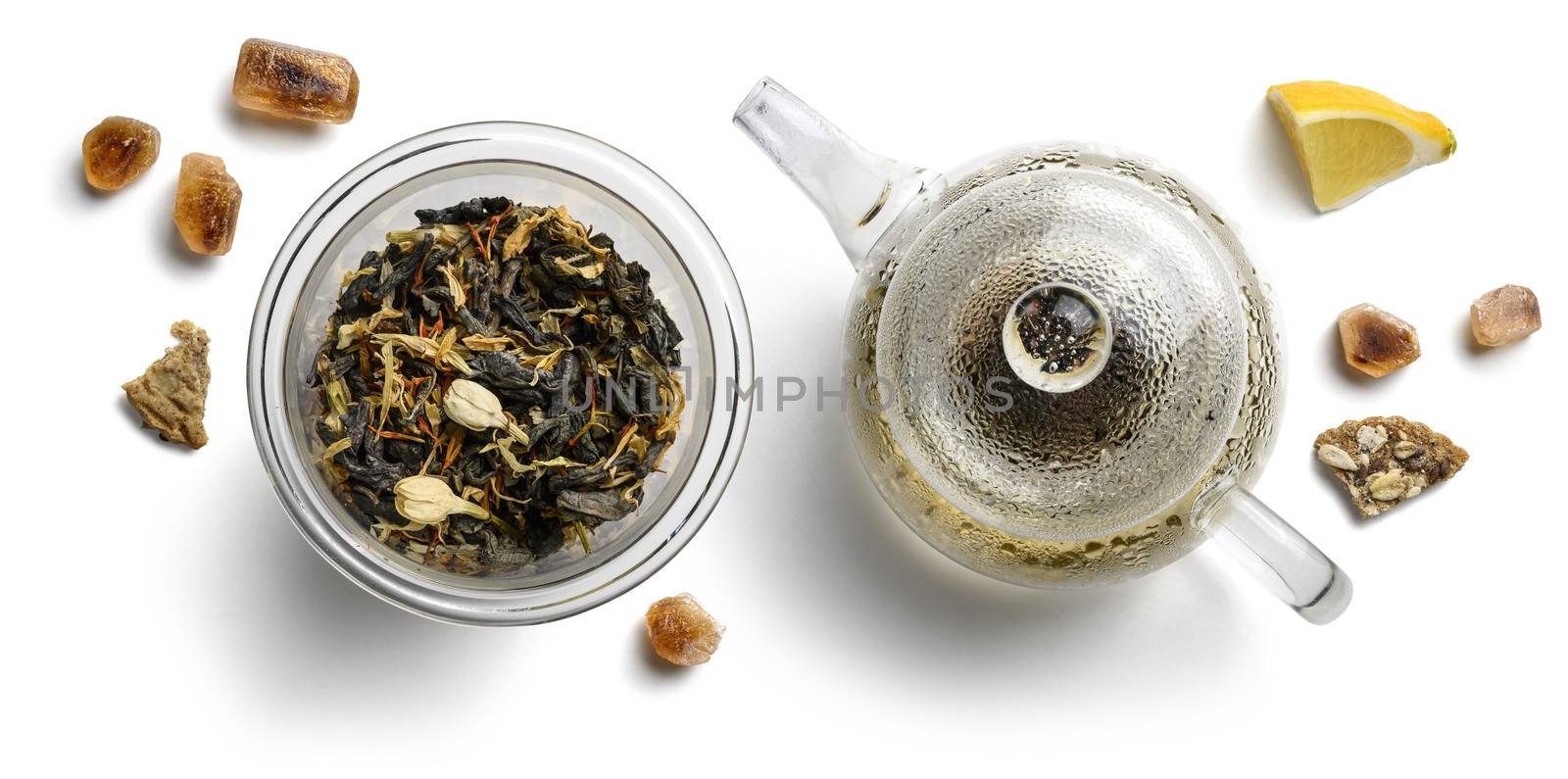 Green tea with natural aromatic additives and a teapot. Top view on white background by butenkow