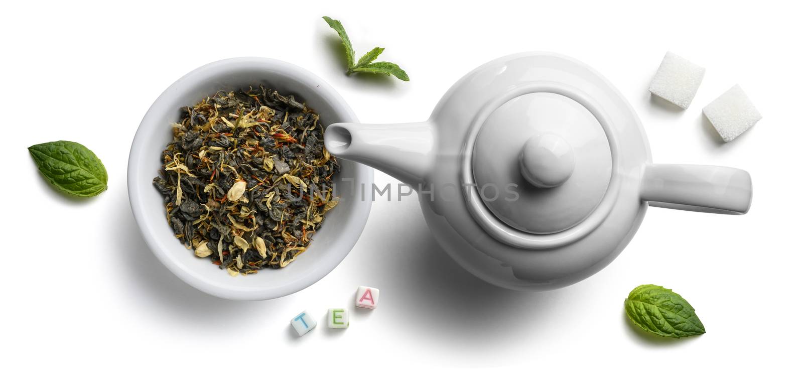 Green tea with natural aromatic additives and a teapot. Top view on white background by butenkow