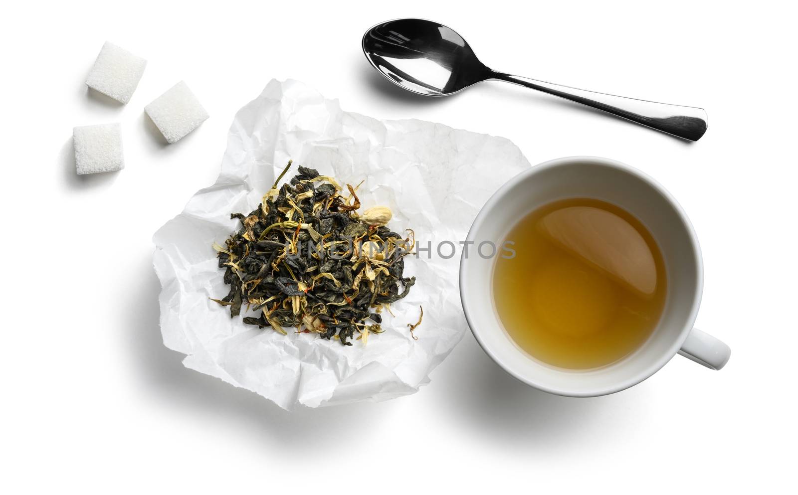 Green tea with natural aromatic additives and a Cup of tea. Top view on white background.
