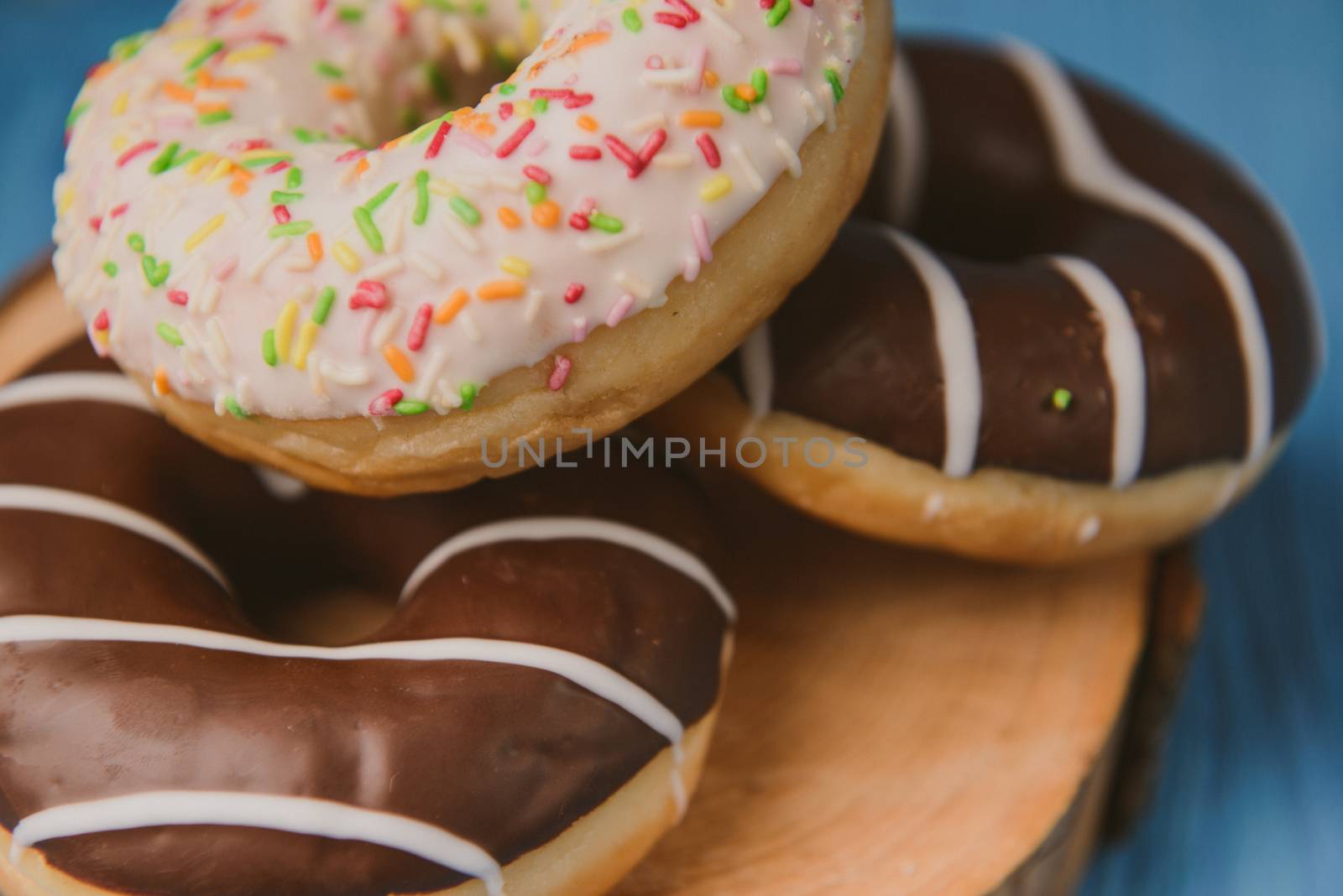 donuts lying on the table. blue background.