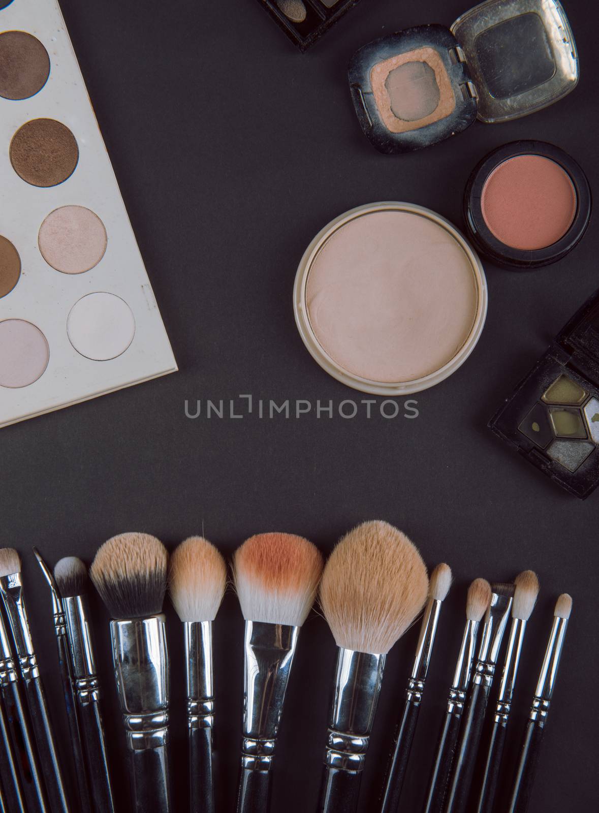 close up of a make up powder and a brush. makeup brush with powder foundation