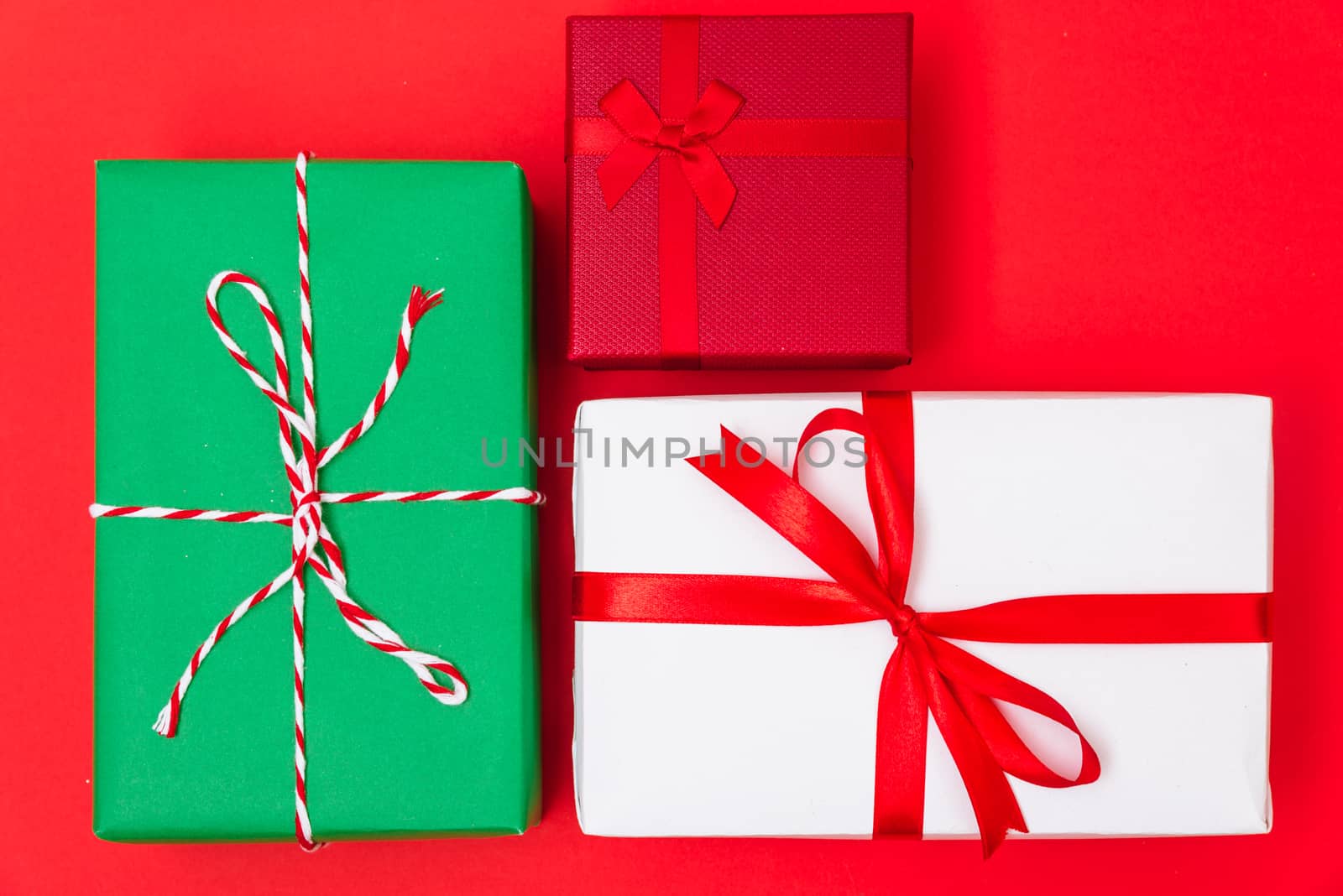 Happy New Year and Christmas 2020 day, top view Xmas multi color gift boxes on red background with copy space for your text