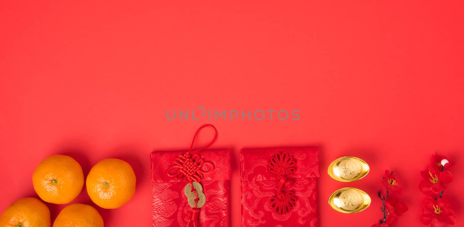 Chinese new year festival concept, flat lay top view, Happy Chinese new year with Red envelope and gold ingot (Character "FU" means fortune, blessing) on red background with copy space for text