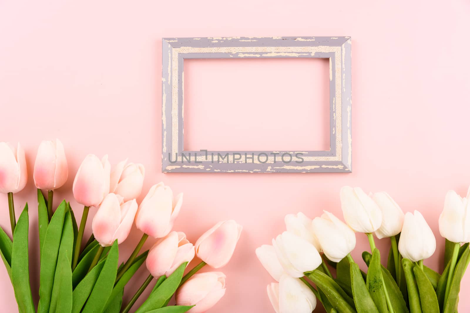 Happy Women's Day, Mother's Day concept. top view flat lay photo frame and Tulip flower on pink background, copy space for your text