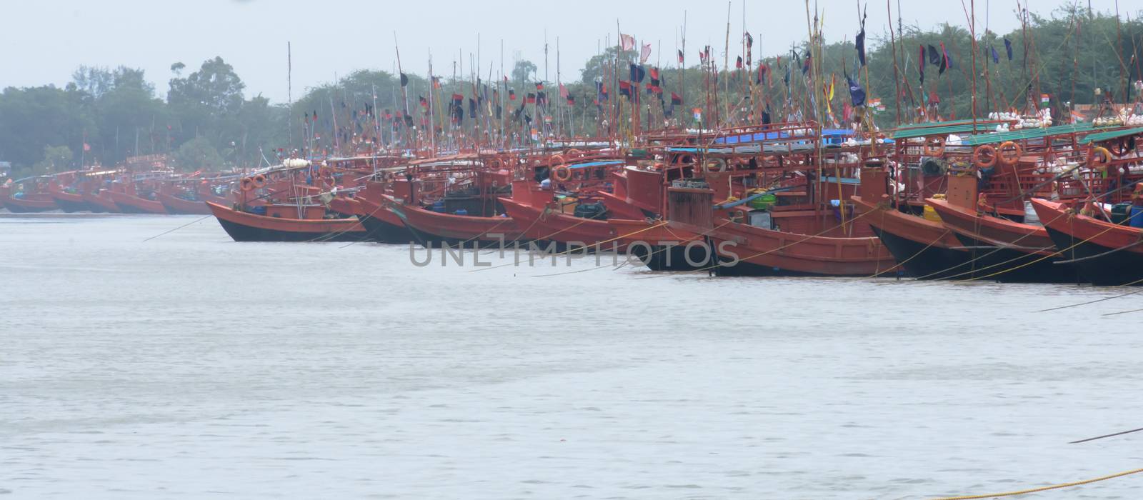 Many Commercial nautical sea vessels like trawler boat ship sailboat, all Red and Black Color code to strength coastal security anchored in protected nautical mile zone area. Midnapore, India May 2019