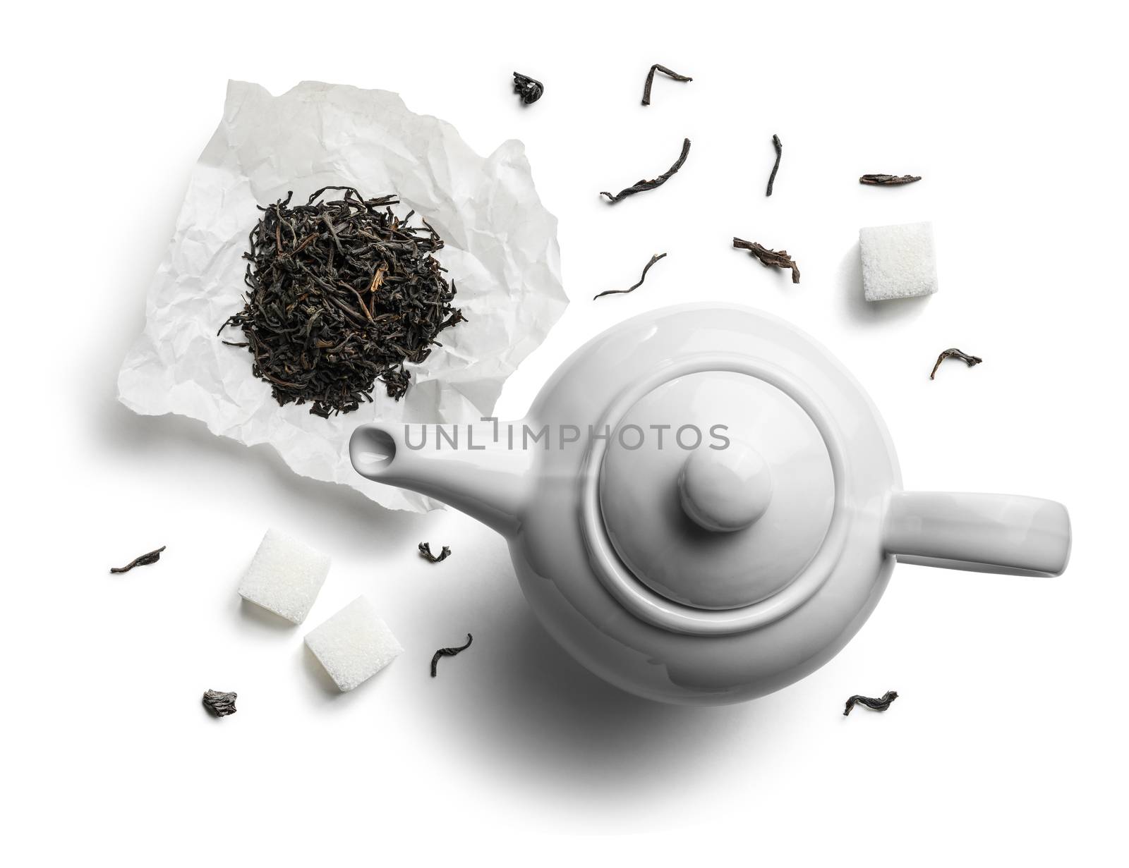 Teapots and tea leaves on a white background. The view from the top.