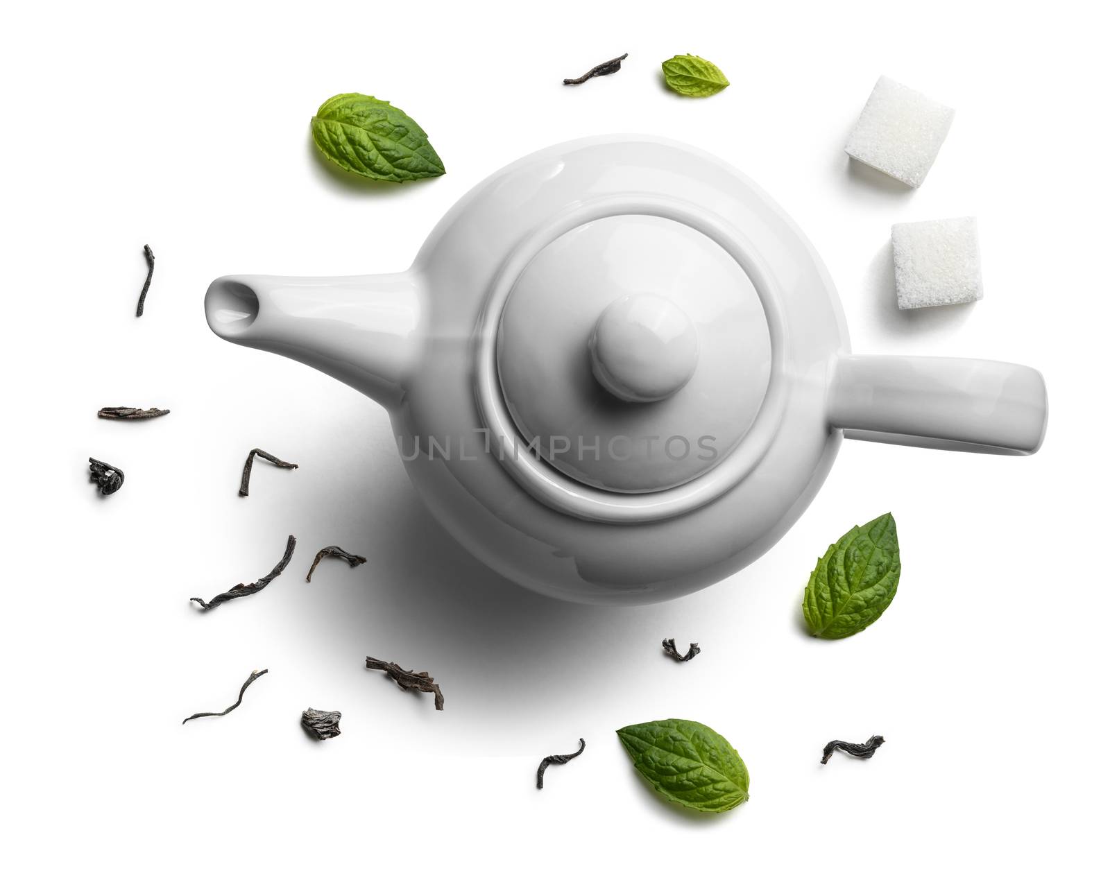 Teapots and tea leaves on a white background. The view from the top.