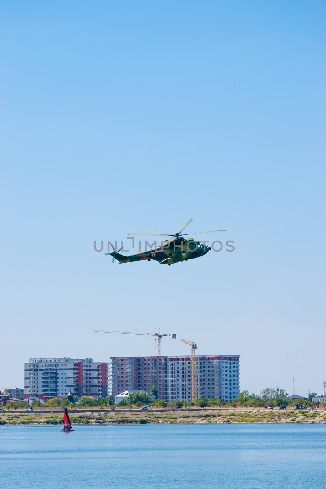 Bucharest/ Romania - AeroNautic Show - September 21, 2019: Puma IAR330 Helicopter flying above the lake by Luca-Mih