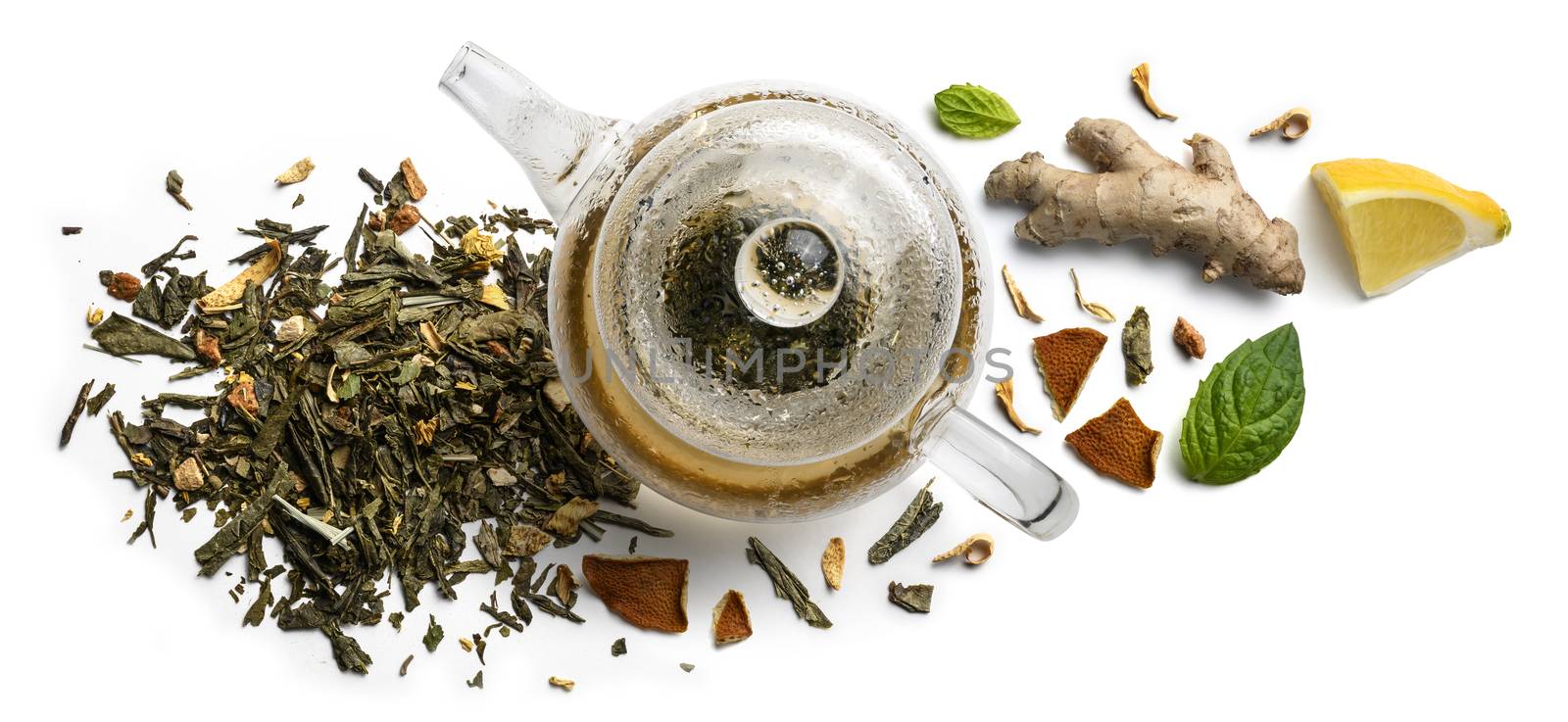 Green tea with natural aromatic additives and a teapot. Top view on white background.
