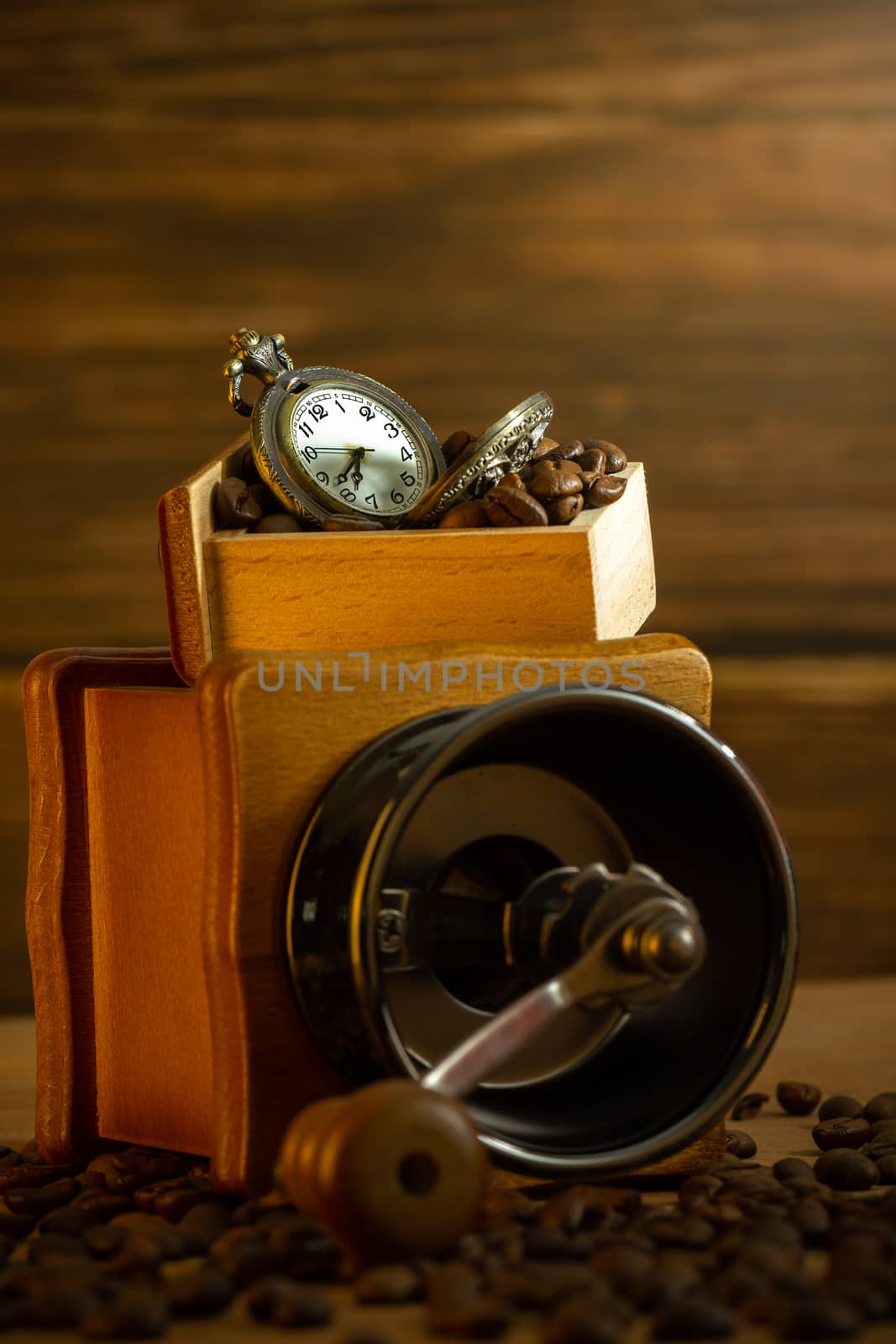 Coffee bean and pocket watch. Manual grinder on table in morning by SaitanSainam