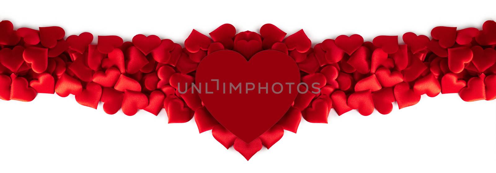 Valentine's day many red silk hearts and red heart shaped card isolated on white background, love concept