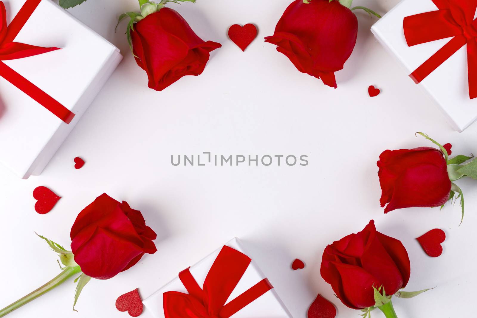 Red rose flowers gifts and red hearts composition on white background top view with copy space. Valentine's day, birthday, wedding, Mother's day concept. Copy space