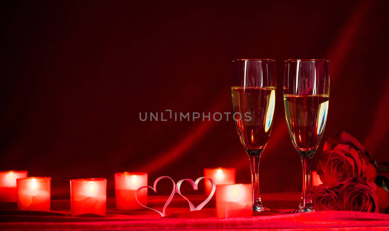Valentines day background with champagne glasses candles and hearts