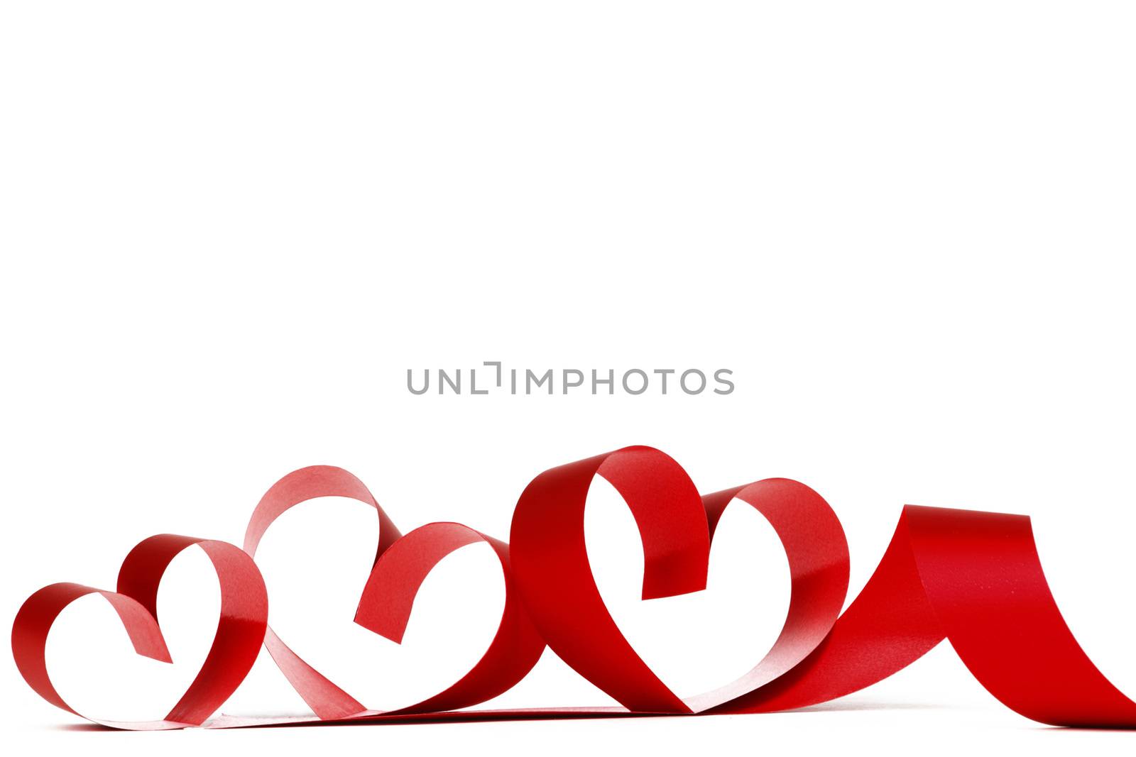 Heart shaped red ribbon isolated on white background