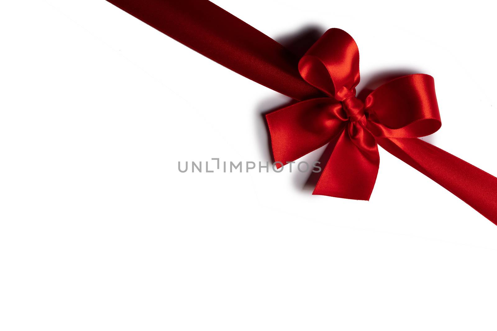 Red satin ribbon bow isolated on white background