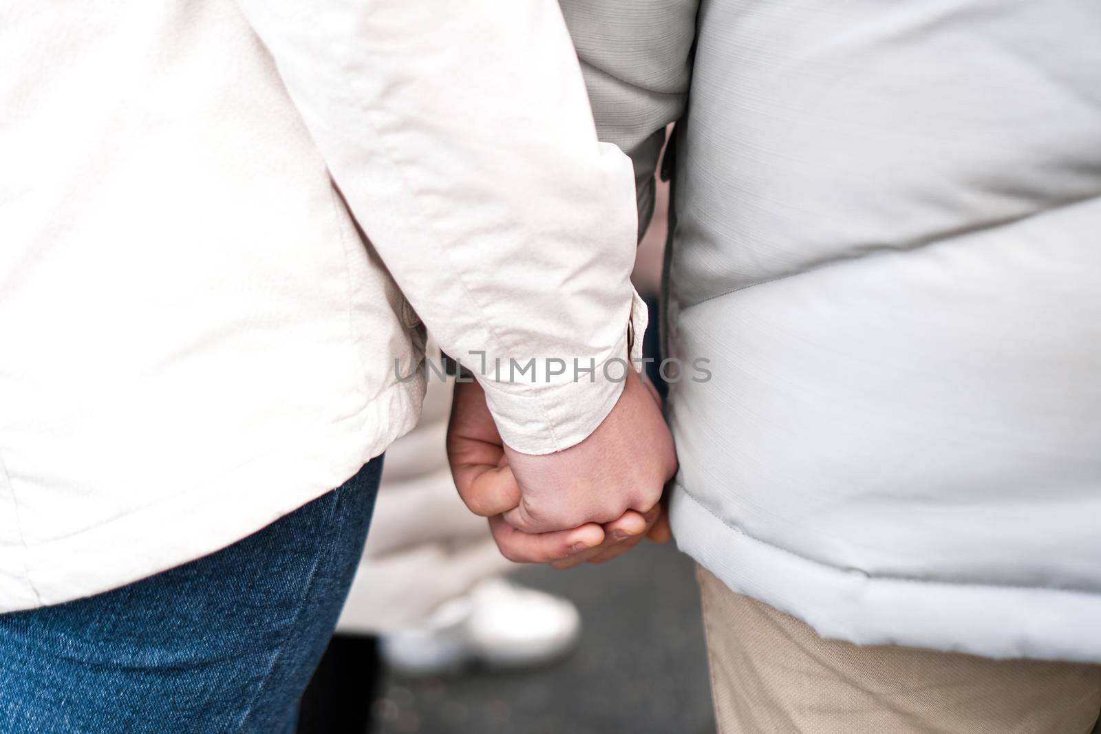 A couple in love holding hands. Closeup