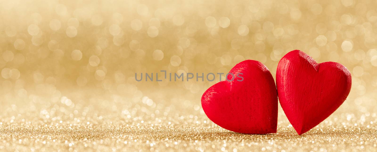 Two red wooden hearts symbol of love on background with beautiful bokeh, Saint Valentine Day celebration, copy space for text