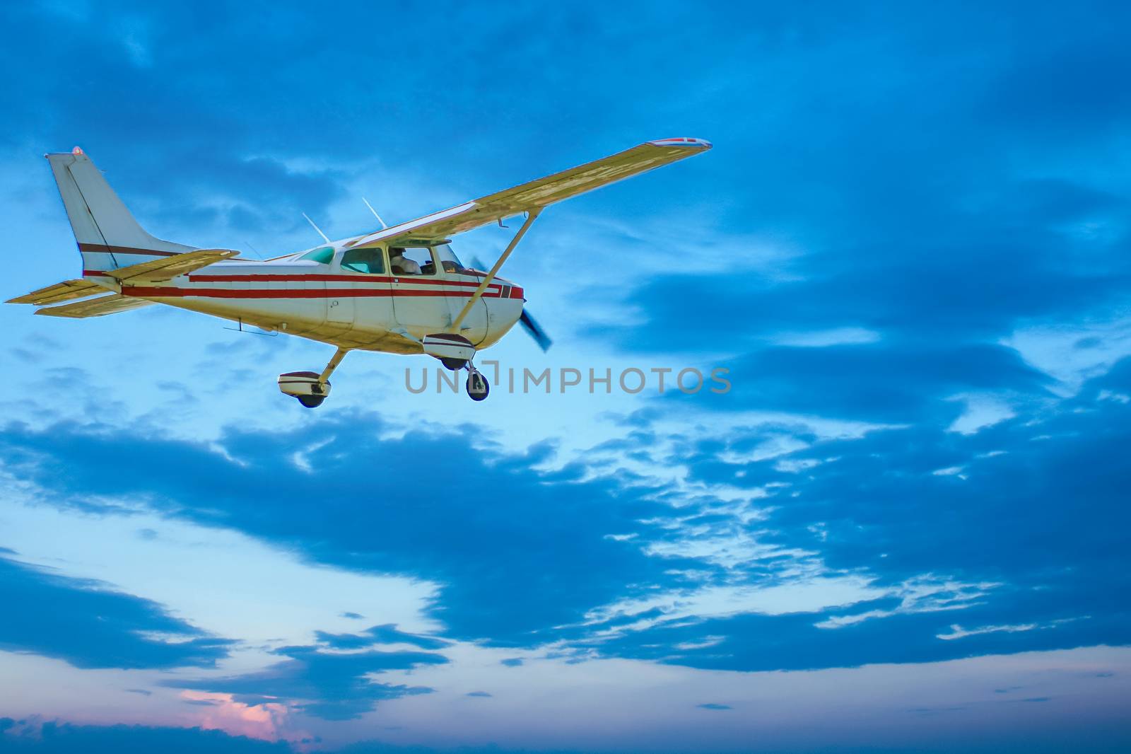 Small Plane Flying Into Dusk by dbvirago