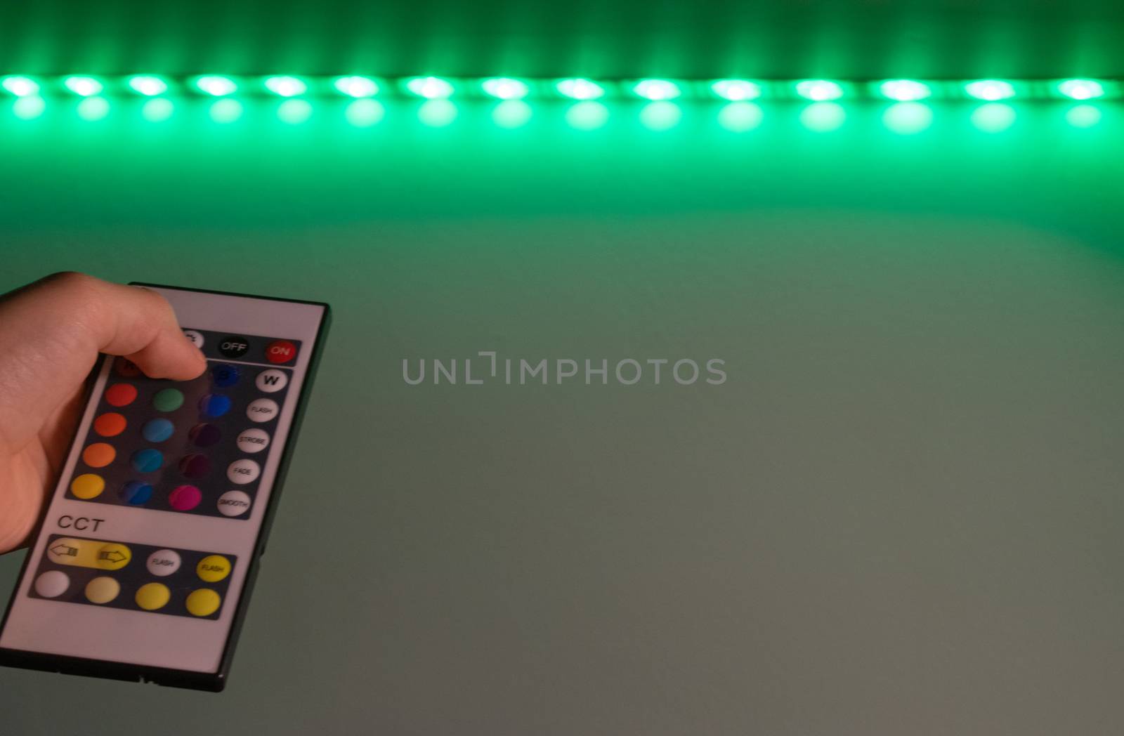 Bucharest / Romania - July 23, 2019: Rgb led remote controller pointing to the led strip by Luca-Mih