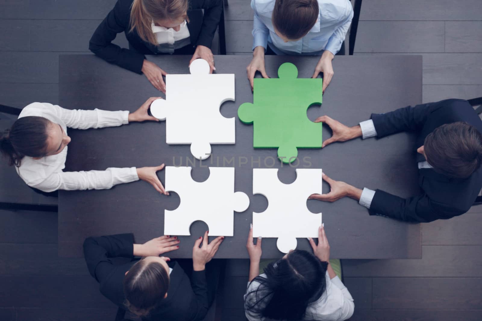 Group of business people assembling jigsaw puzzle, team support and help concept