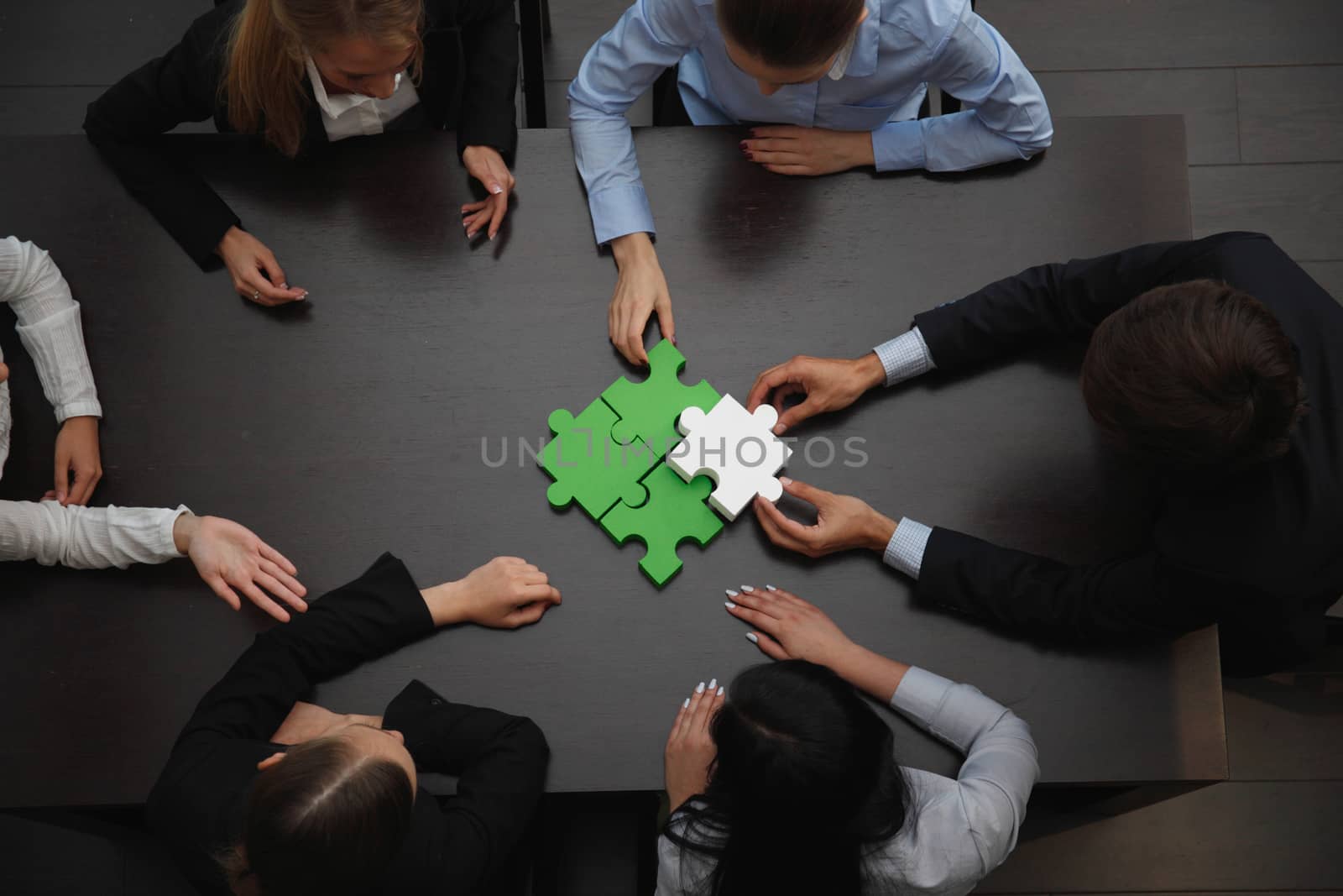 Group of business people assembling jigsaw puzzle, team support and help concept