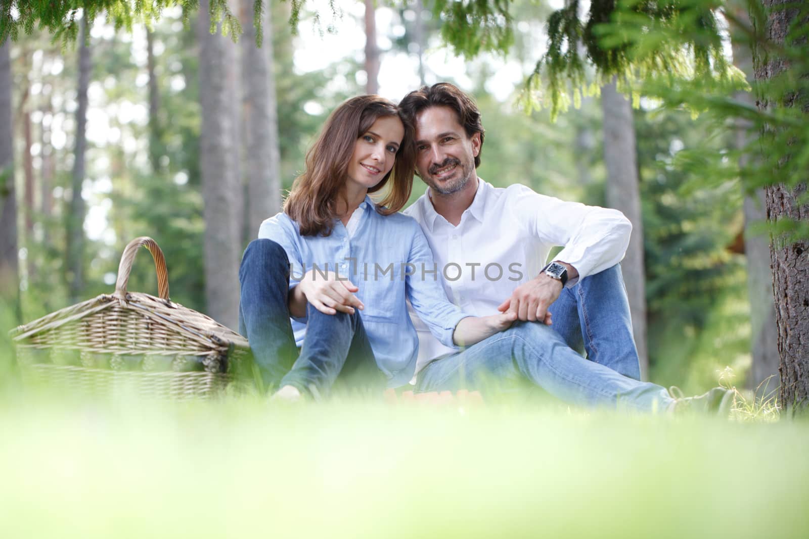 Young beautiful couple on picnic in summer park
