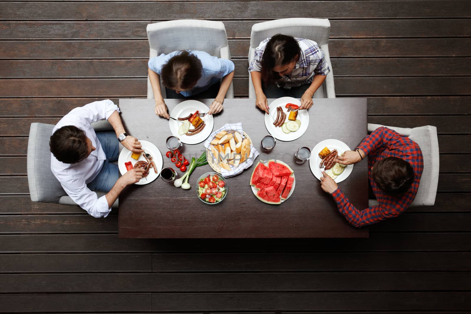 Four friends having dinner, top view