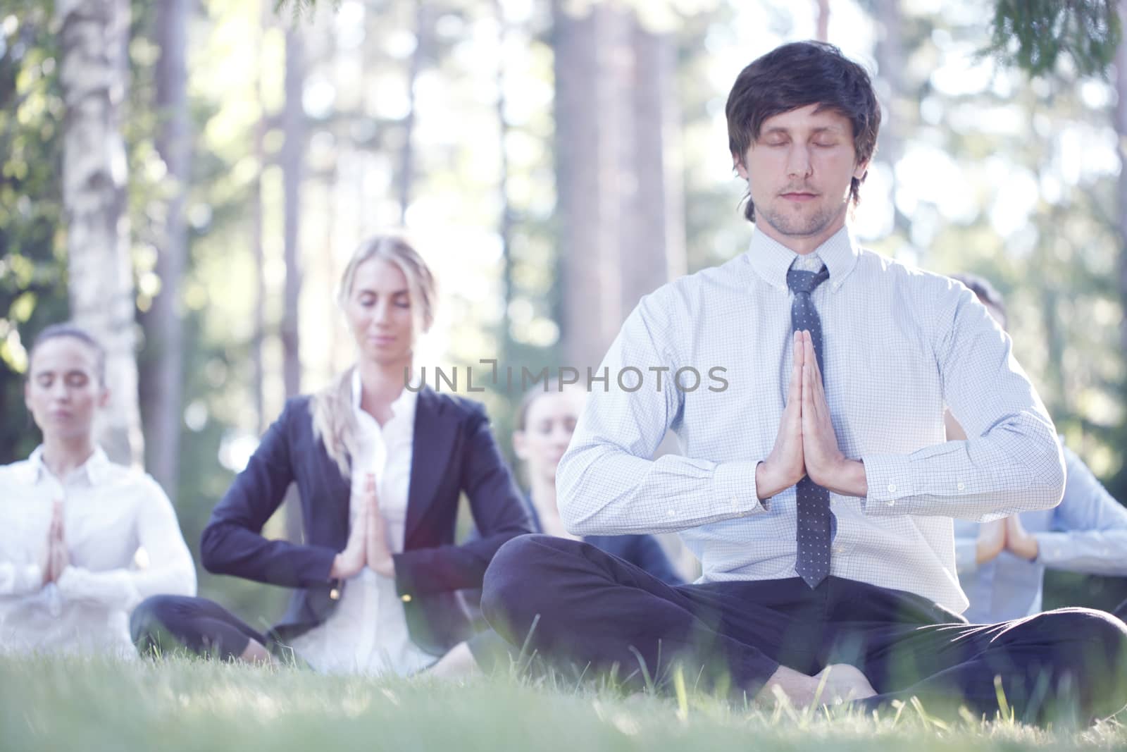Business people practicing yoga by ALotOfPeople