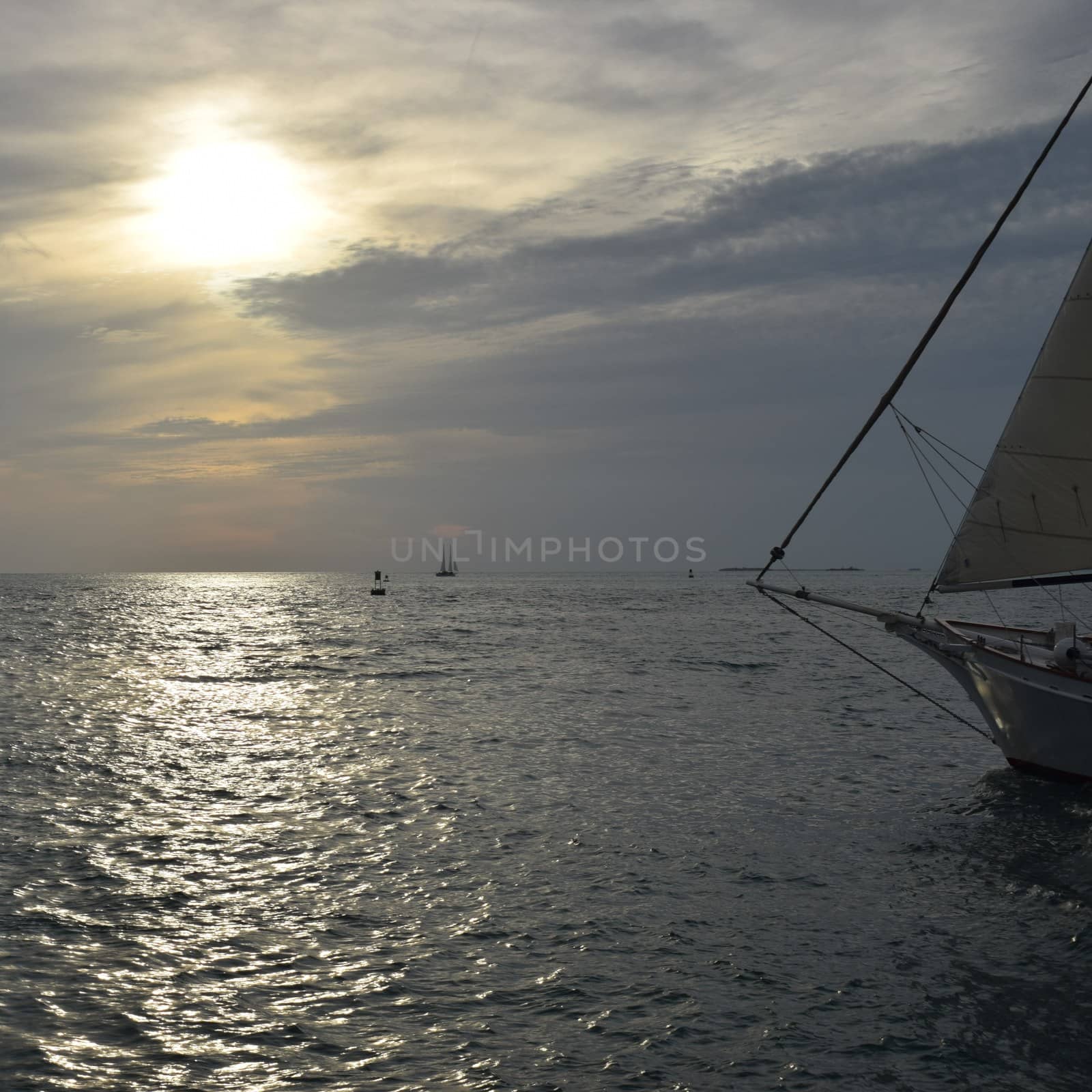Sailboat on Ocean against Sunset Sky by TheDutchcowboy