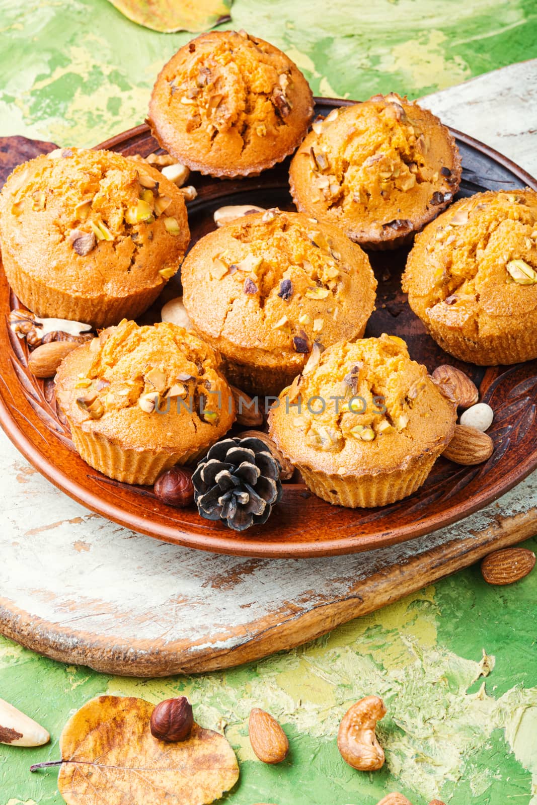 Homemade muffins with nuts on a plate.