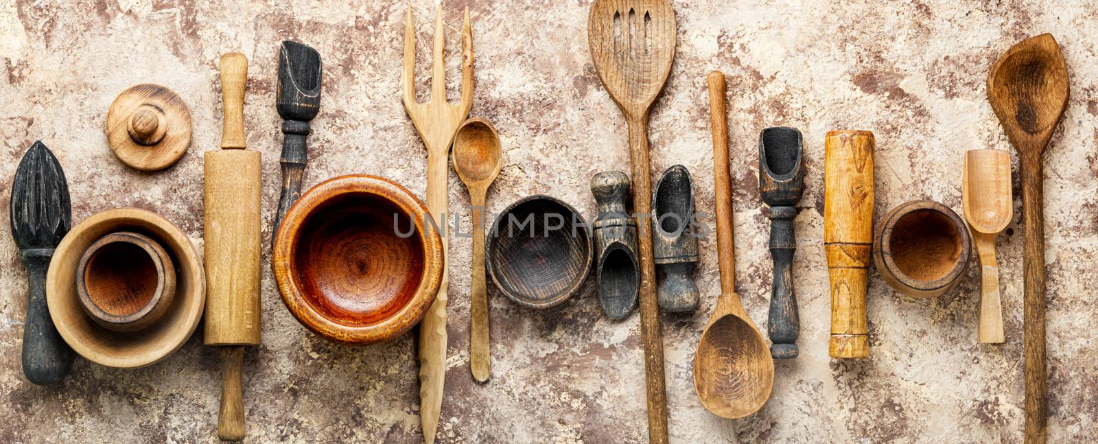 Concept of wooden rustic kitchenware utensils set on old background.Cutlery set