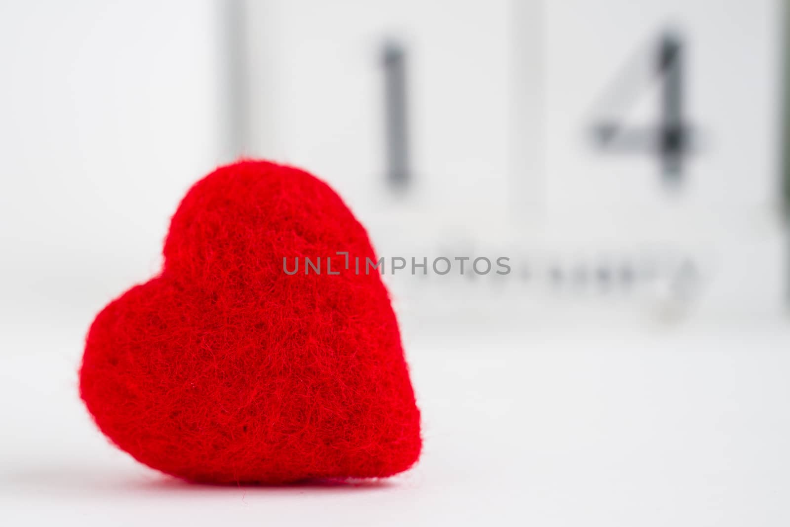 Cube calendar with red heart isolated on white. Valentines day